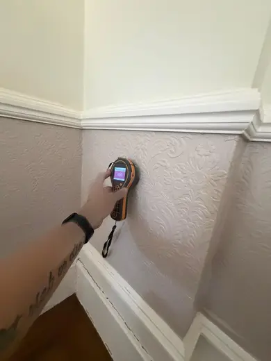 Moisture meter reading 690 REL in the reception room