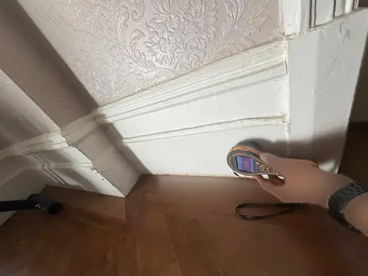 Moisture meter reading 615 REL in the reception room