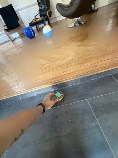 Moisture meter reading 142 REL in the kitchen