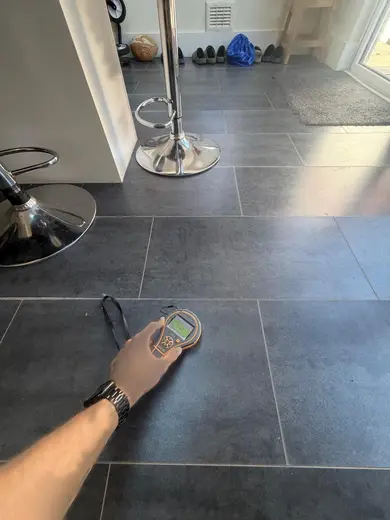 Moisture meter reading 145 REL in the kitchen