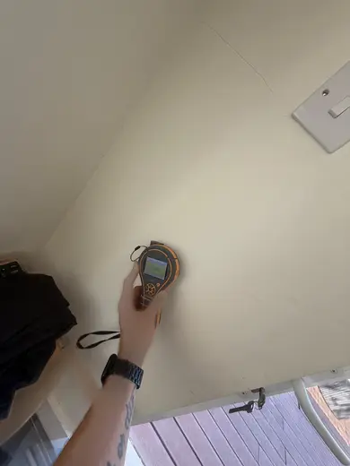 Moisture meter reading 199 REL in the kitchen
