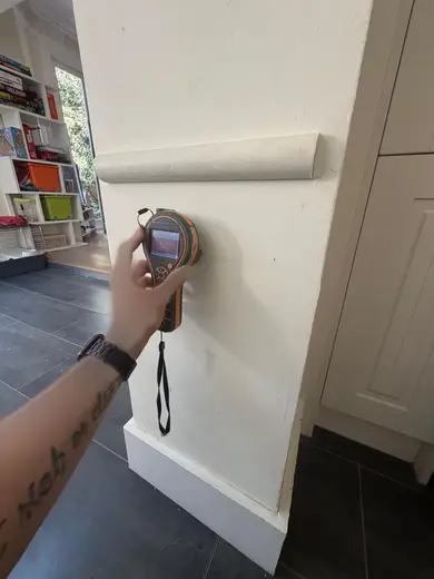 Moisture meter reading 537 REL in the kitchen