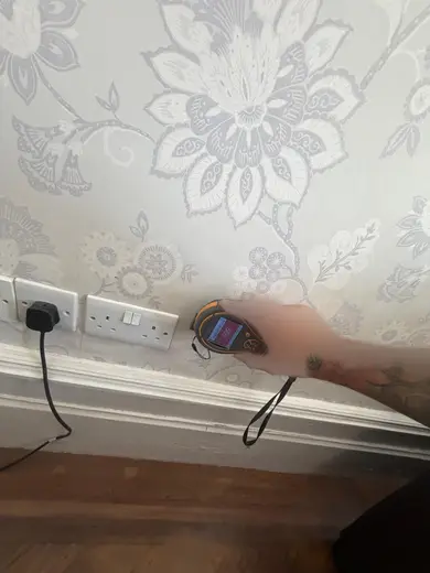Moisture meter reading 999 REL in the front living room