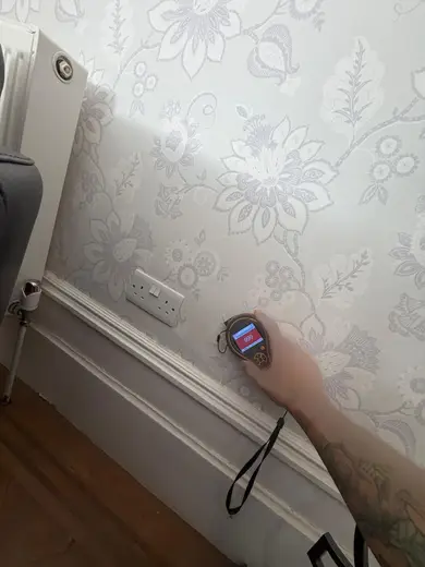 Moisture meter reading 999 REL in the front living room