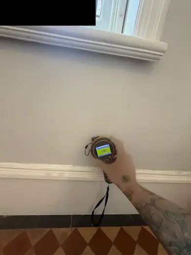 Moisture meter reading 190 REL in the entrance hallway