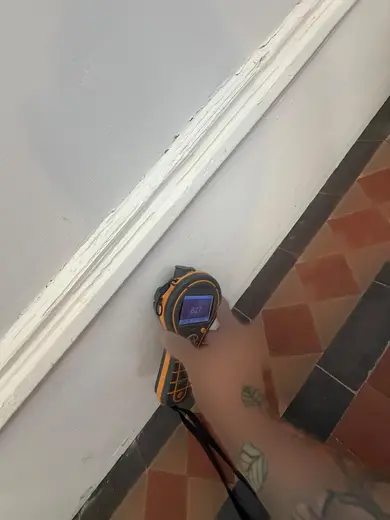 Moisture meter reading 827 REL in the entrance hallway