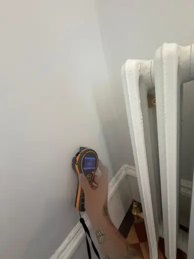 Moisture meter reading 669 REL in the entrance hallway