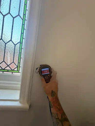 Moisture meter reading 412 REL in the entrance hallway