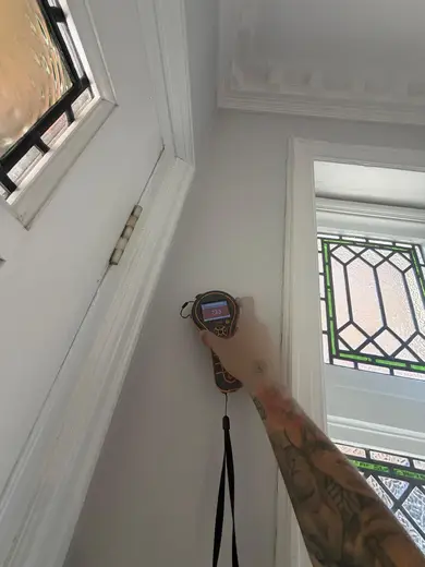 Moisture meter reading 733 REL in the entrance hallway