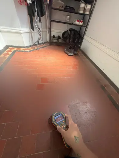 Moisture meter reading 719 REL in the entrance hallway