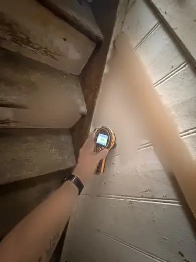 Moisture meter reading 178 REL in the entrance hallway