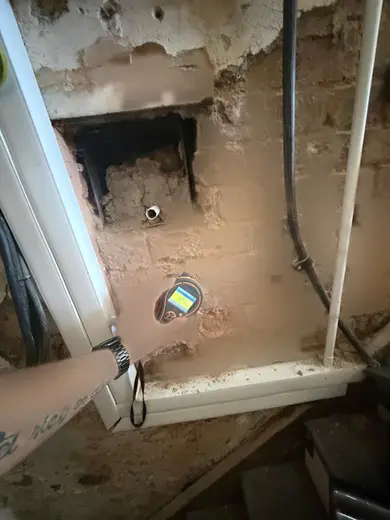 Moisture meter reading 173 REL in the entrance hallway