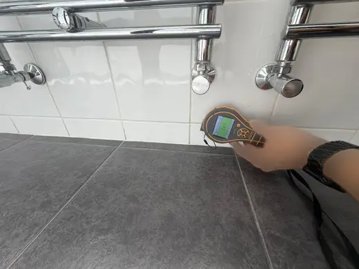 Moisture meter reading 147 REL in the 1st floor bathroom
