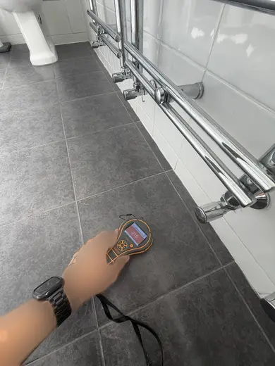 Moisture meter reading 315 REL in the 1st floor bathroom