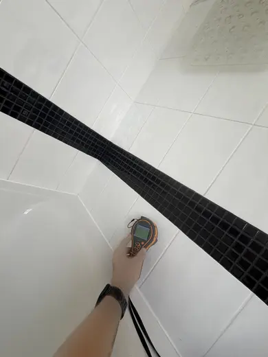 Moisture meter reading 149 REL in the 1st floor bathroom