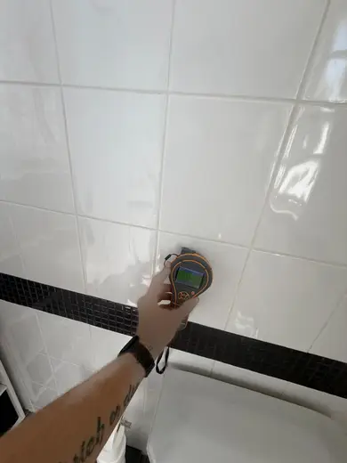 Moisture meter reading 163 REL in the 1st floor bathroom
